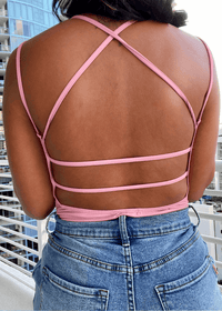 Get trendy with Criss-Cross Pink Bodysuit - Tops available at ELLE TENAJ. Grab yours for $10 today!